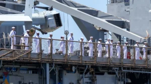 Sailors man the rails aboard amphibious landing dock USS Harpers Ferry (LSD 49)
