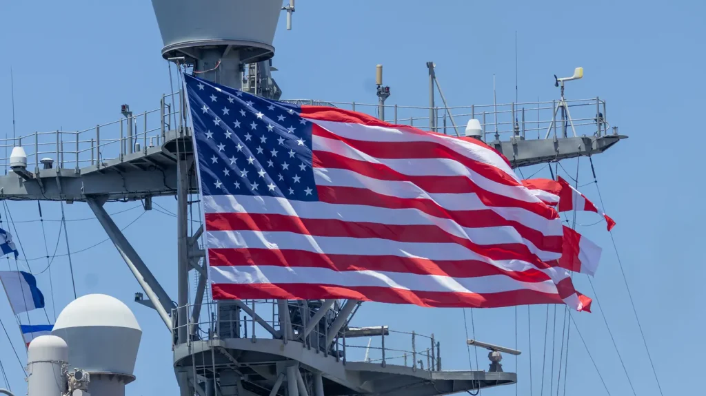 Sailors man the rails aboard amphibious landing dock USS Harpers Ferry (LSD 49)